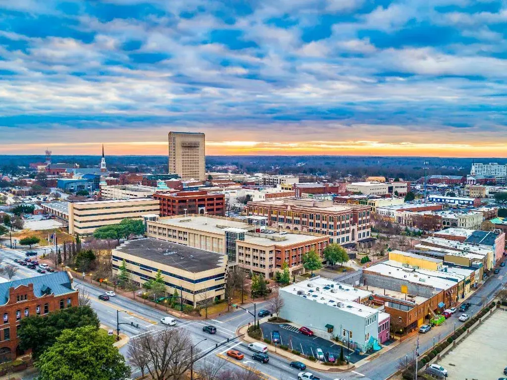 Aerial view of downtown Spartanburg, SC at sunset with office buildings, and roads