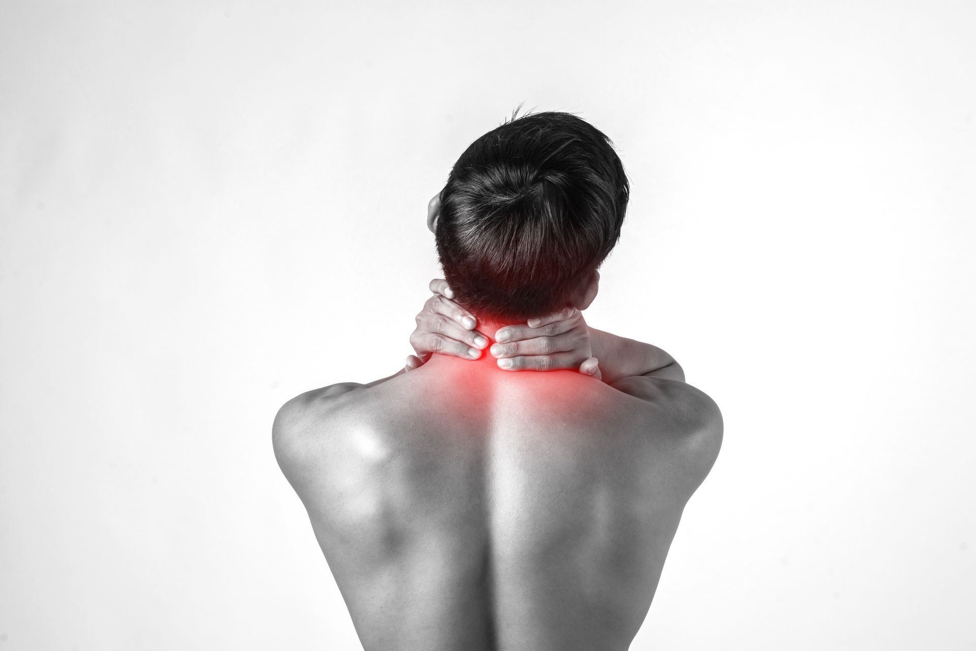 A man is holding his neck in pain.