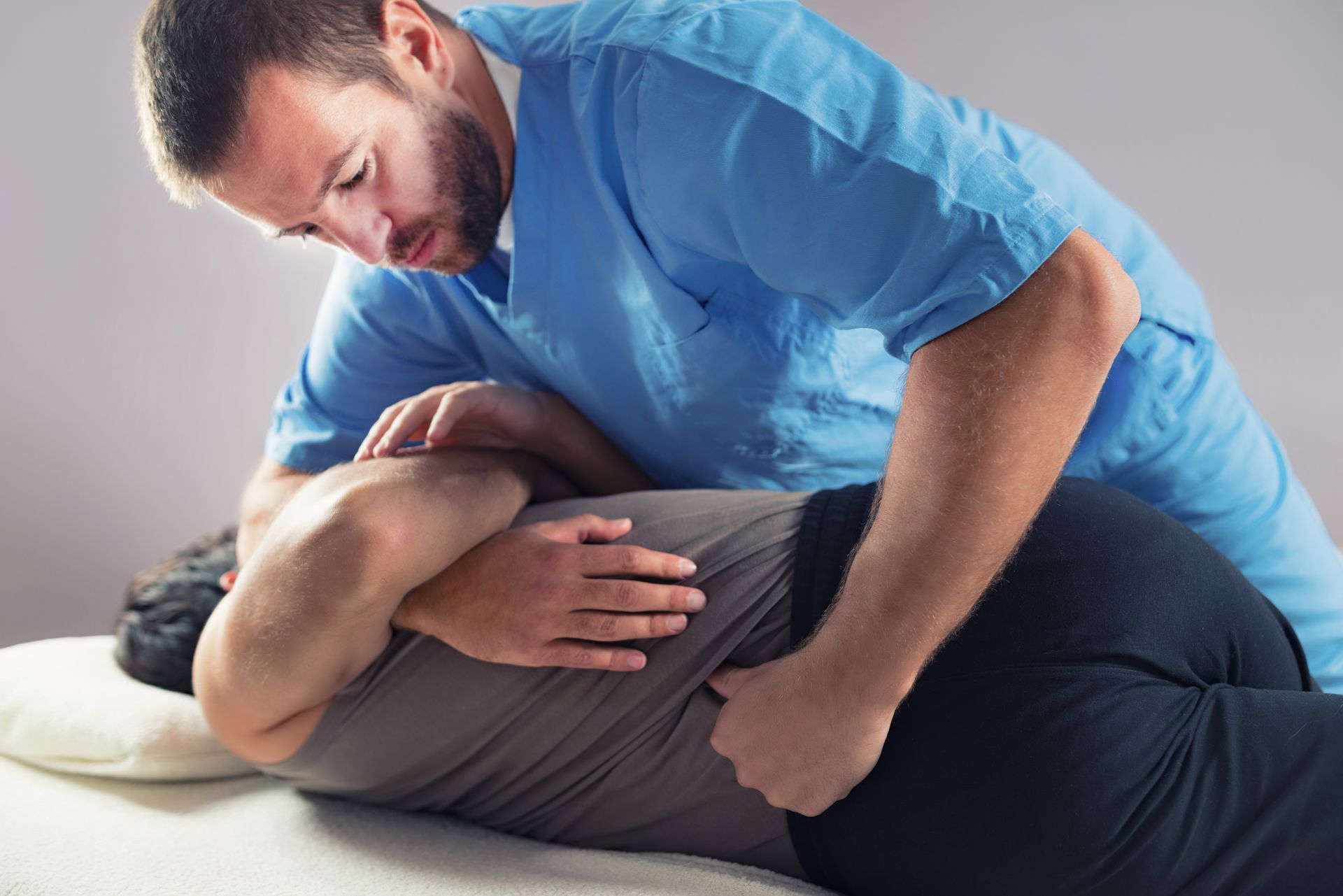 A man is giving a woman a massage on a table.