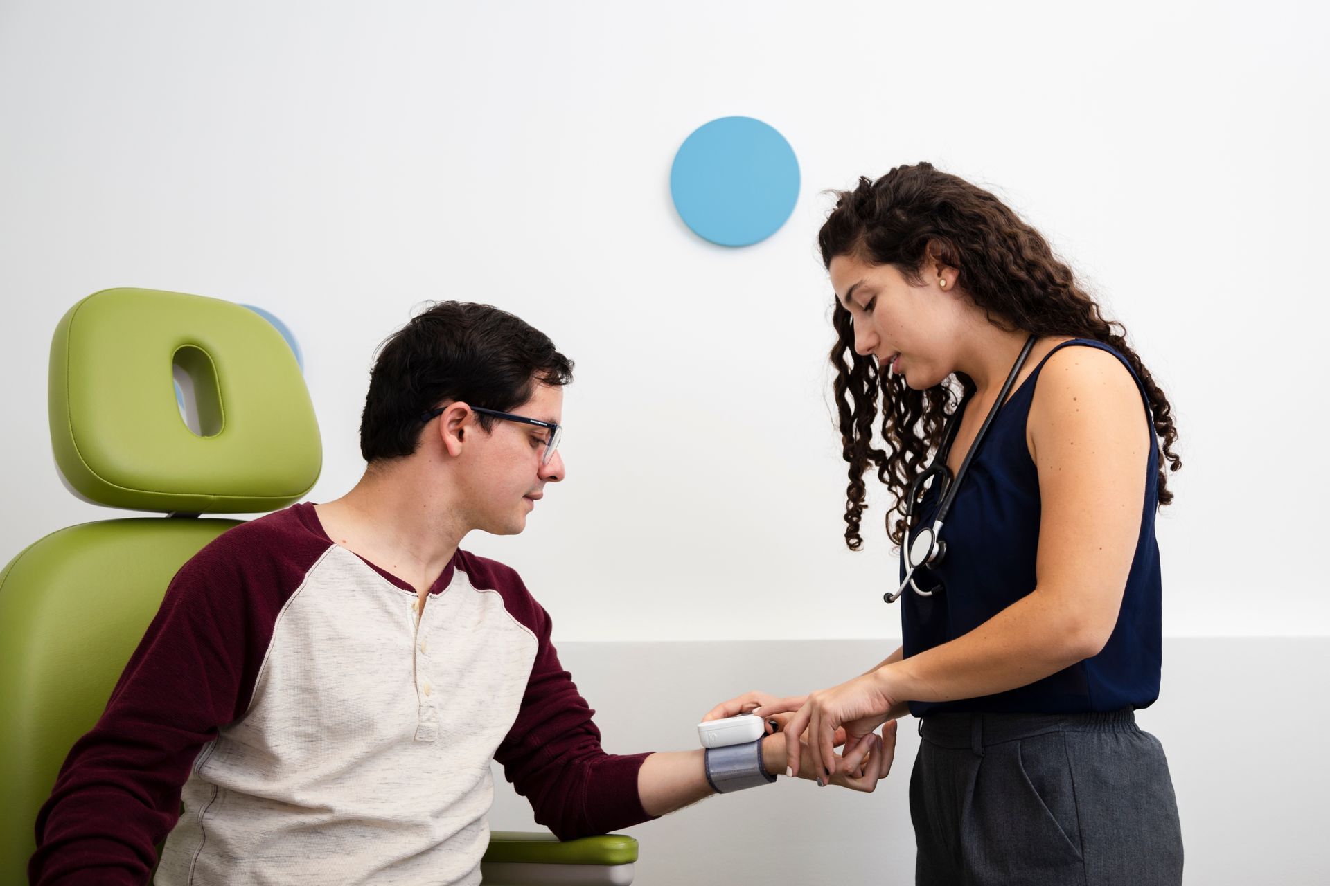 a woman checking a man's vitals
