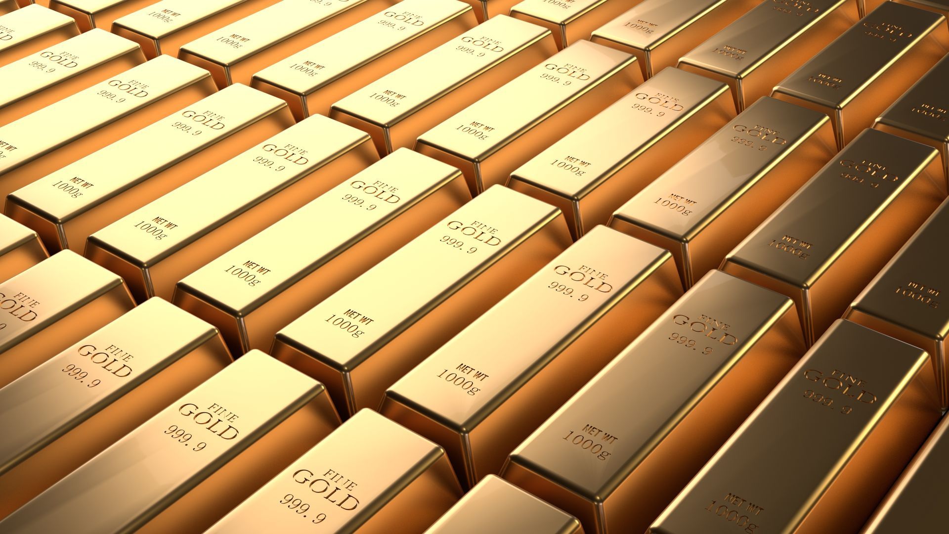 Close-up of stacked rows of 1 kg fine gold bullion bars stamped 999.9 purity