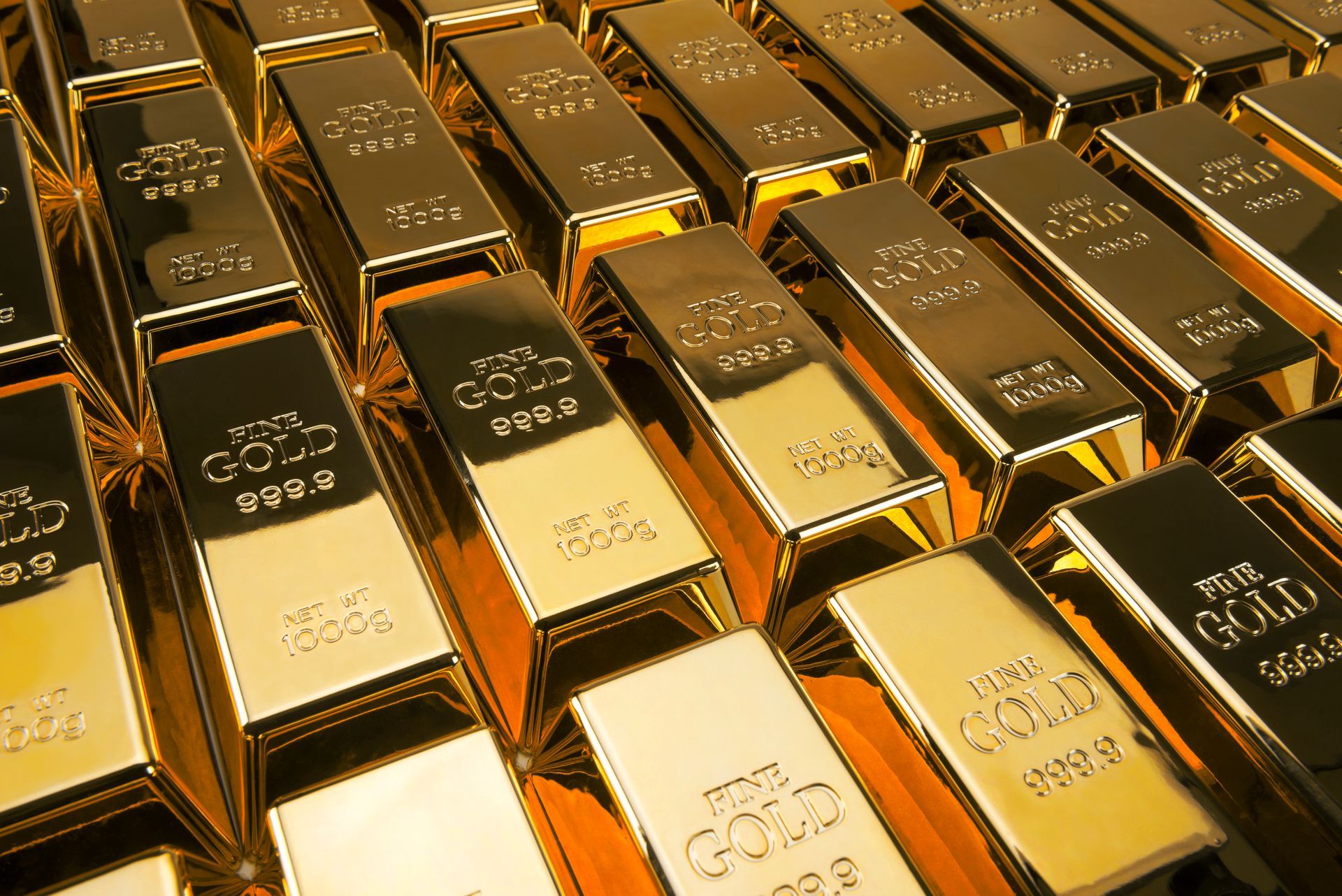 999.9 and 1000 g gold bars lined in rows. 999.9 and 1000 g gold bars lined in rows.