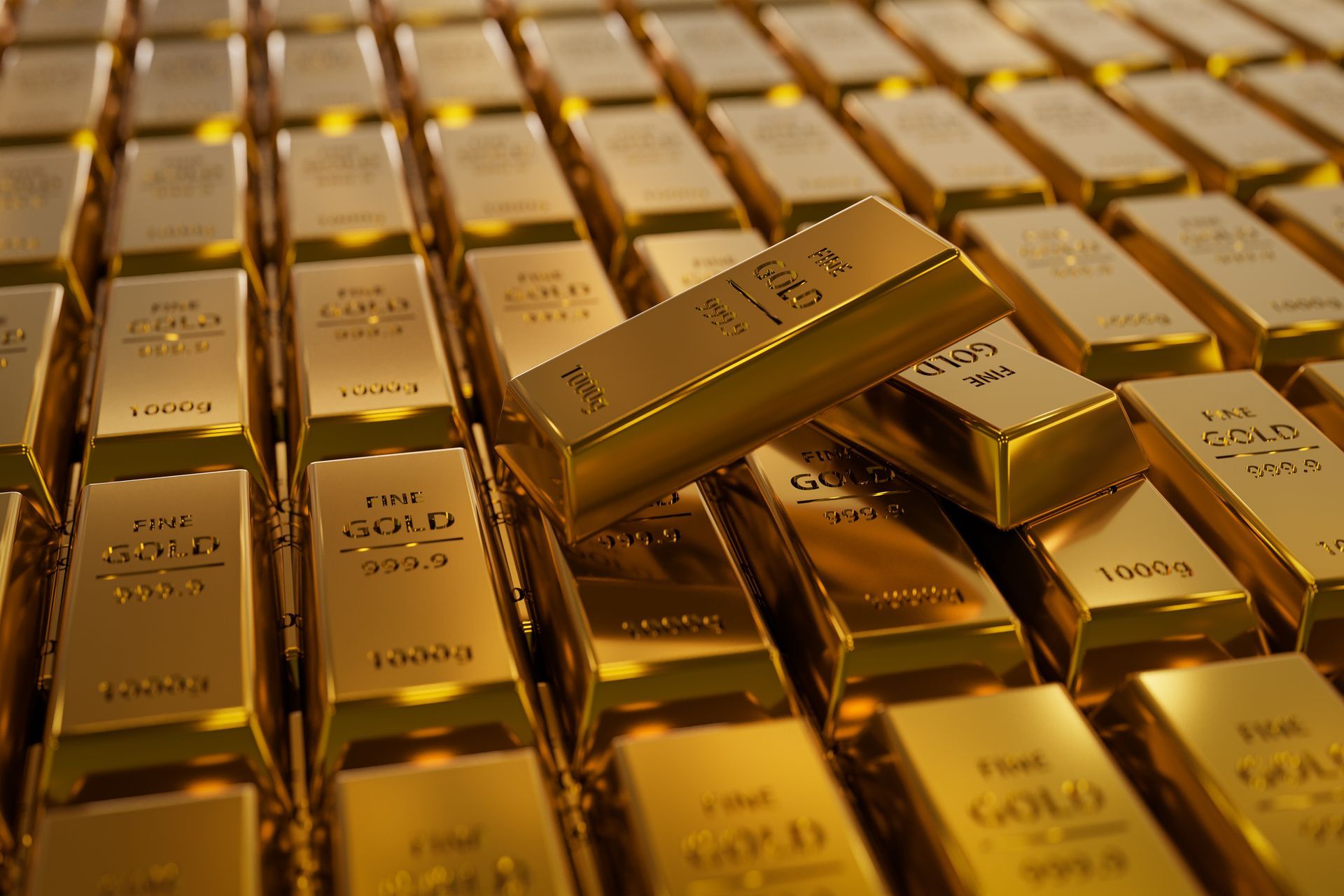 Two gold bars rest on stacked 1kg 999.9 fine gold ingots, symbolizing wealth and precious metal value.