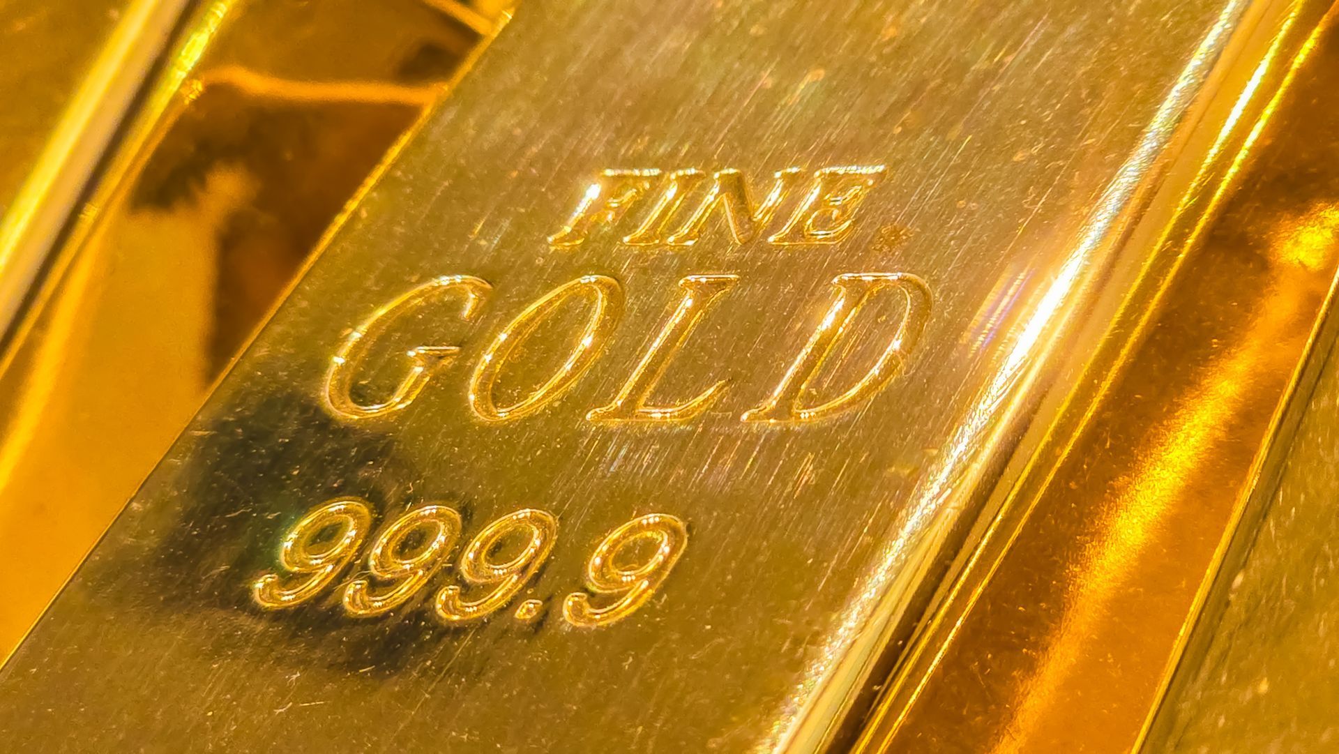 A fine gold bar stamped with 999.99 purity, indicating its high gold content.