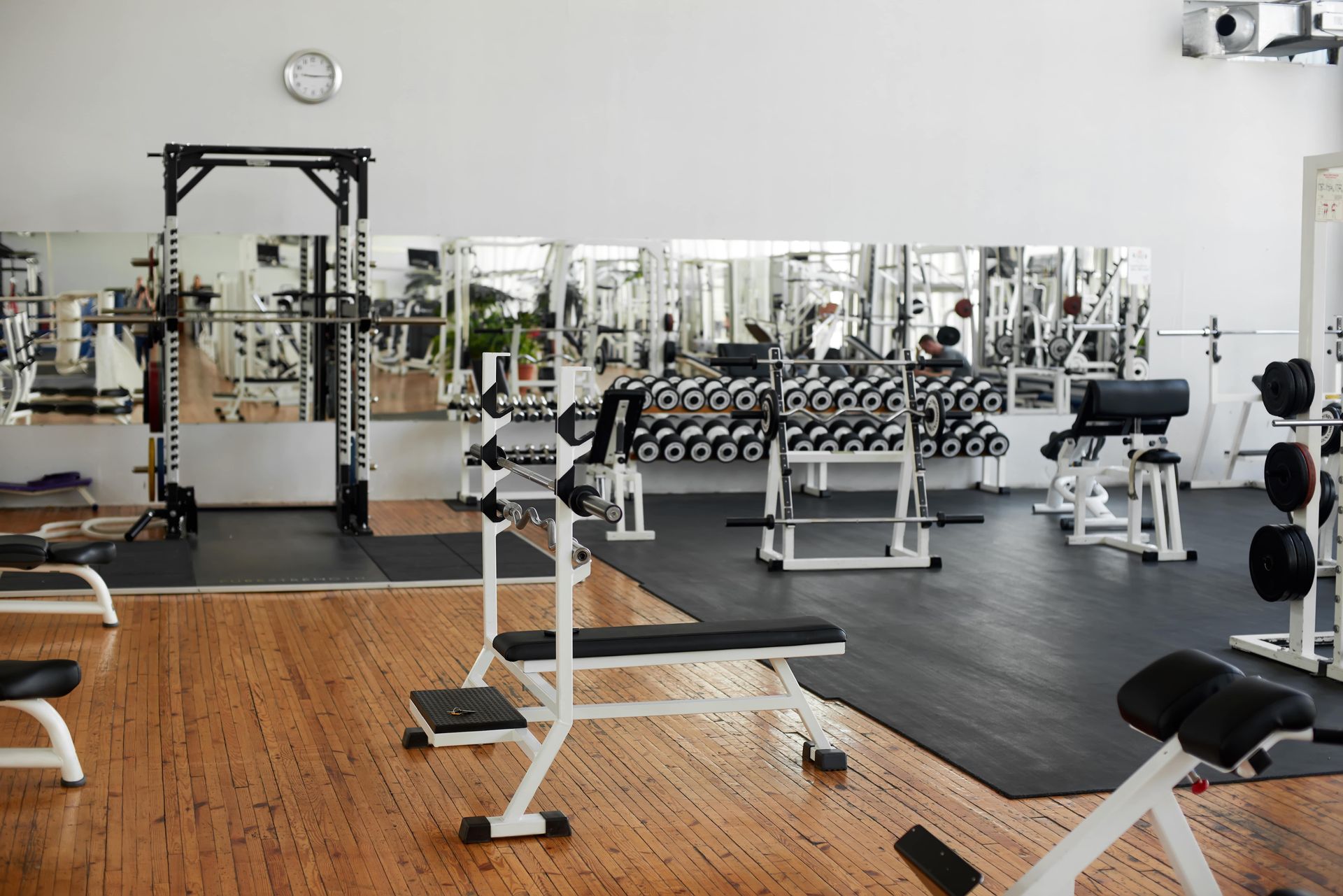 Gym interior with weightlifting equipment.