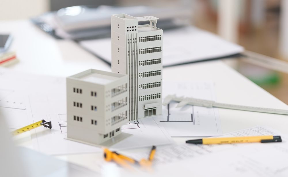 A model of a building is sitting on top of a table.