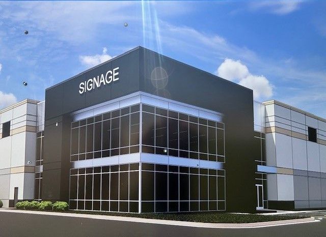 An artist 's impression of a large building with the word signage on it.