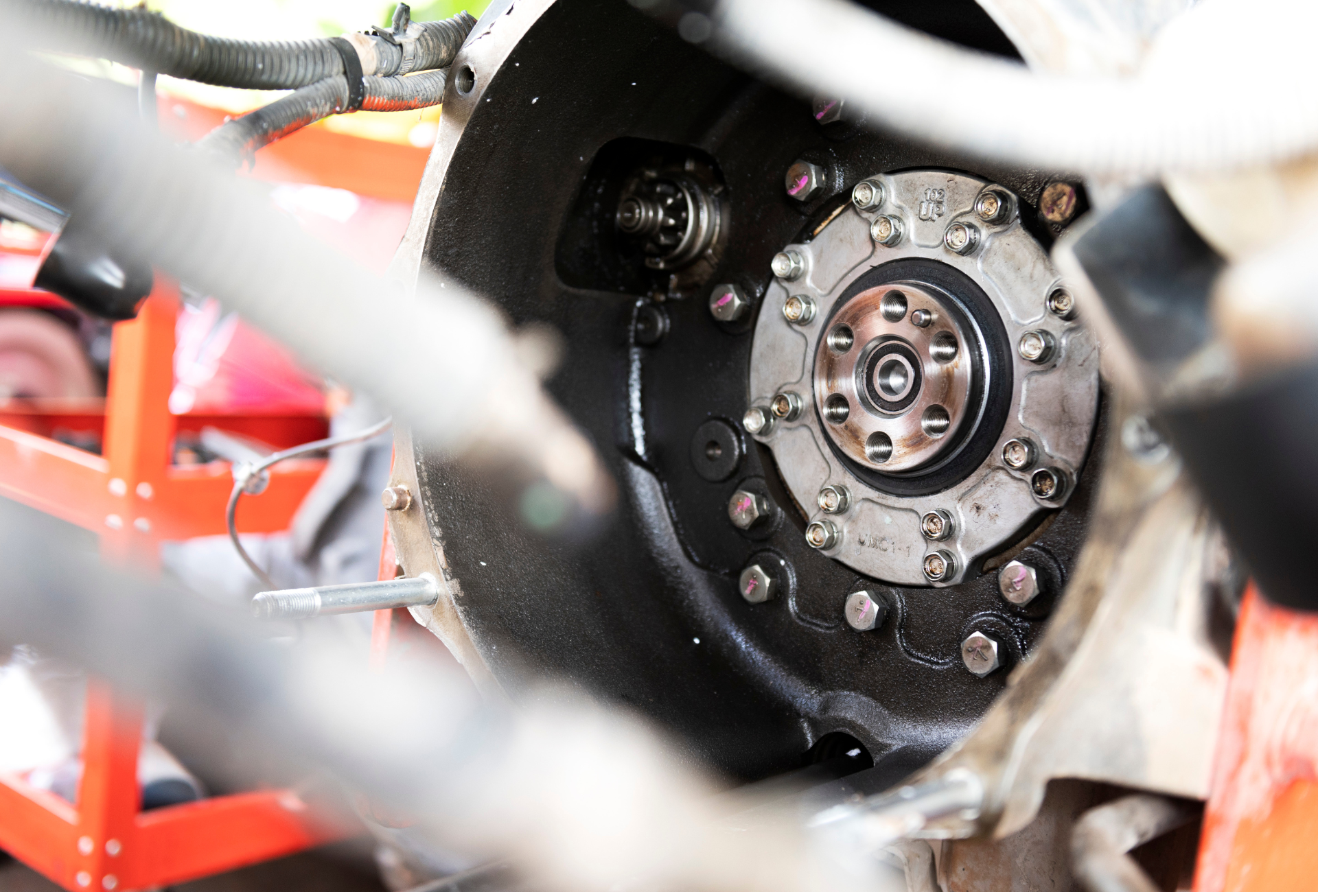 A close up of a person working on a tractor engine.