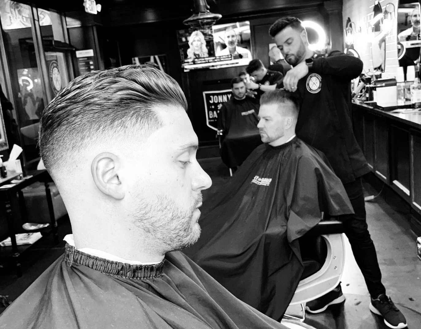 Jonny cutting hair in our barbershop in Buffalo, NY