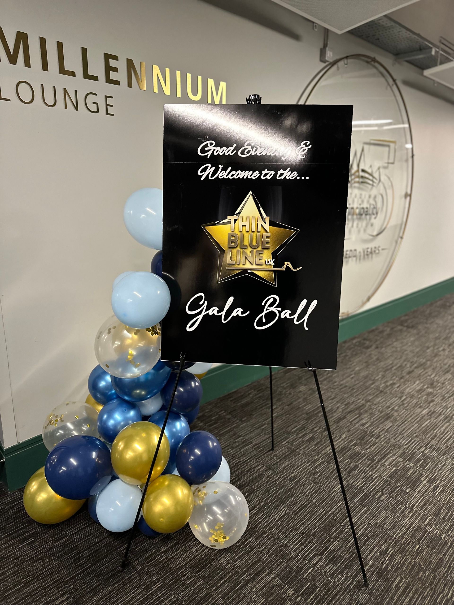 Sign for a Gala Ball with balloons; Millennium Lounge in background.