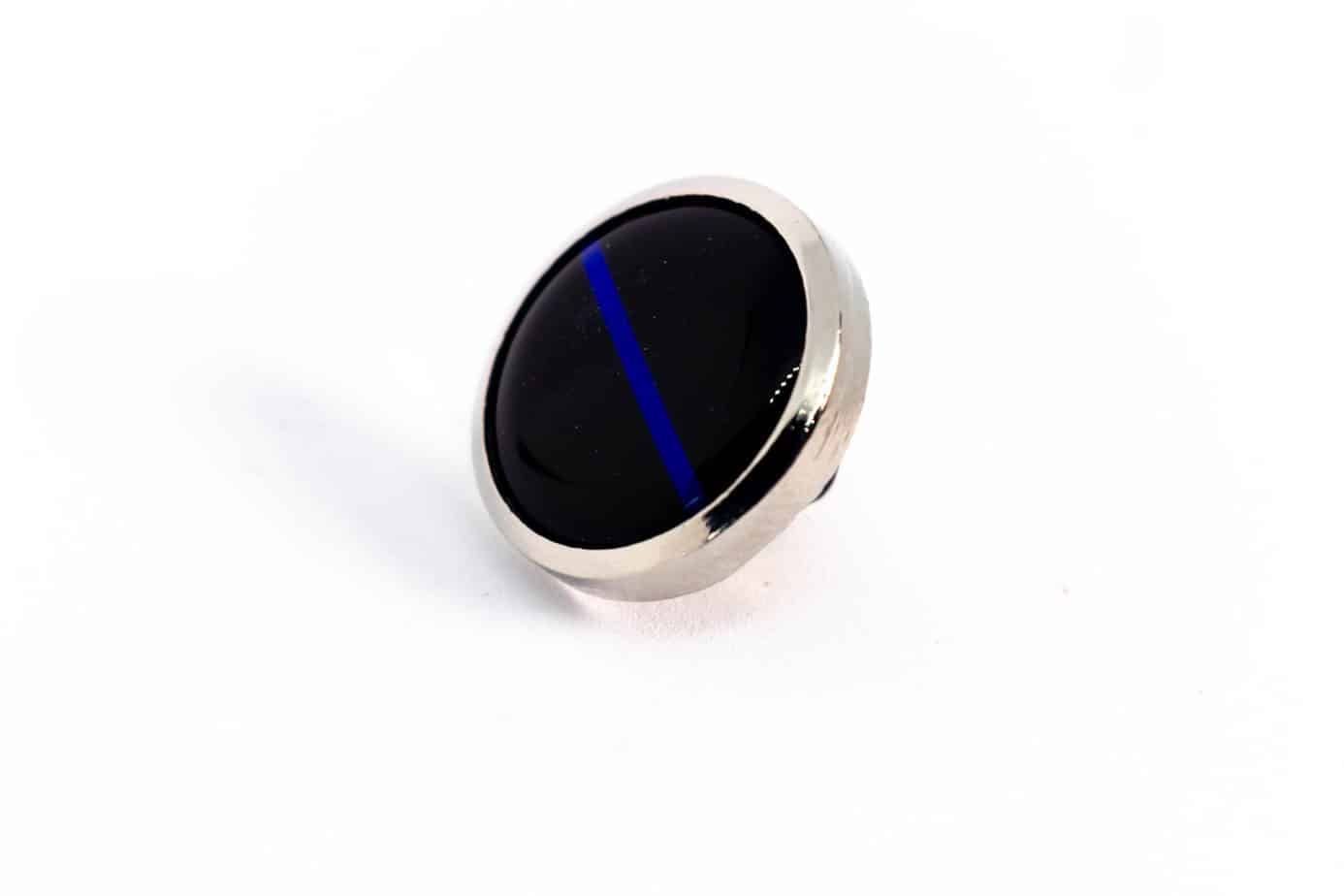 Pin with a black face, silver border, and blue line.