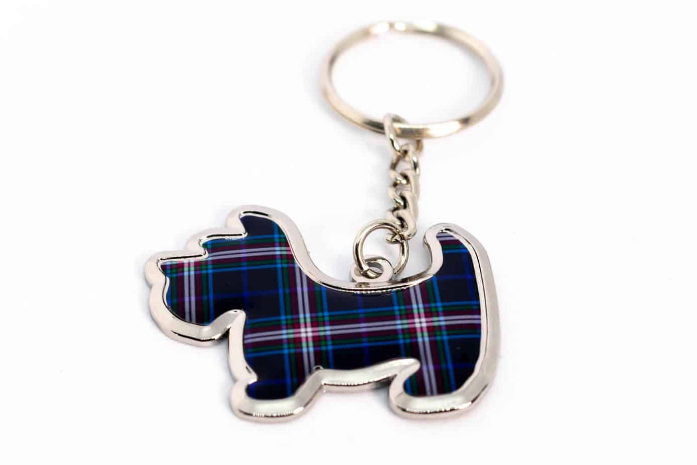 Keychain in the shape of a Scottish terrier, featuring blue and red plaid pattern, on a white background.