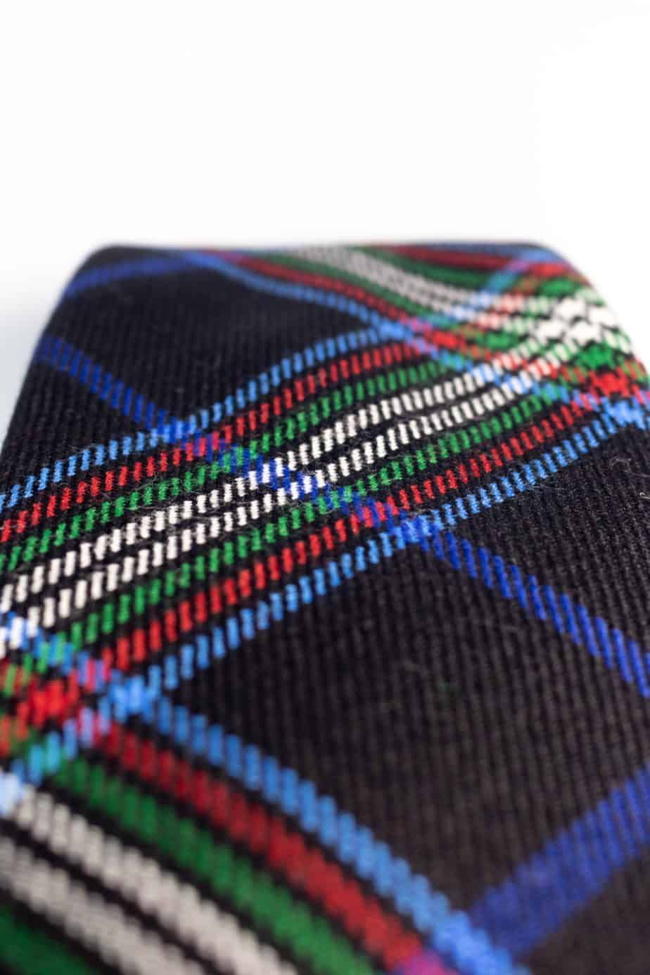 Black plaid necktie with blue, green, red, and white stripes.