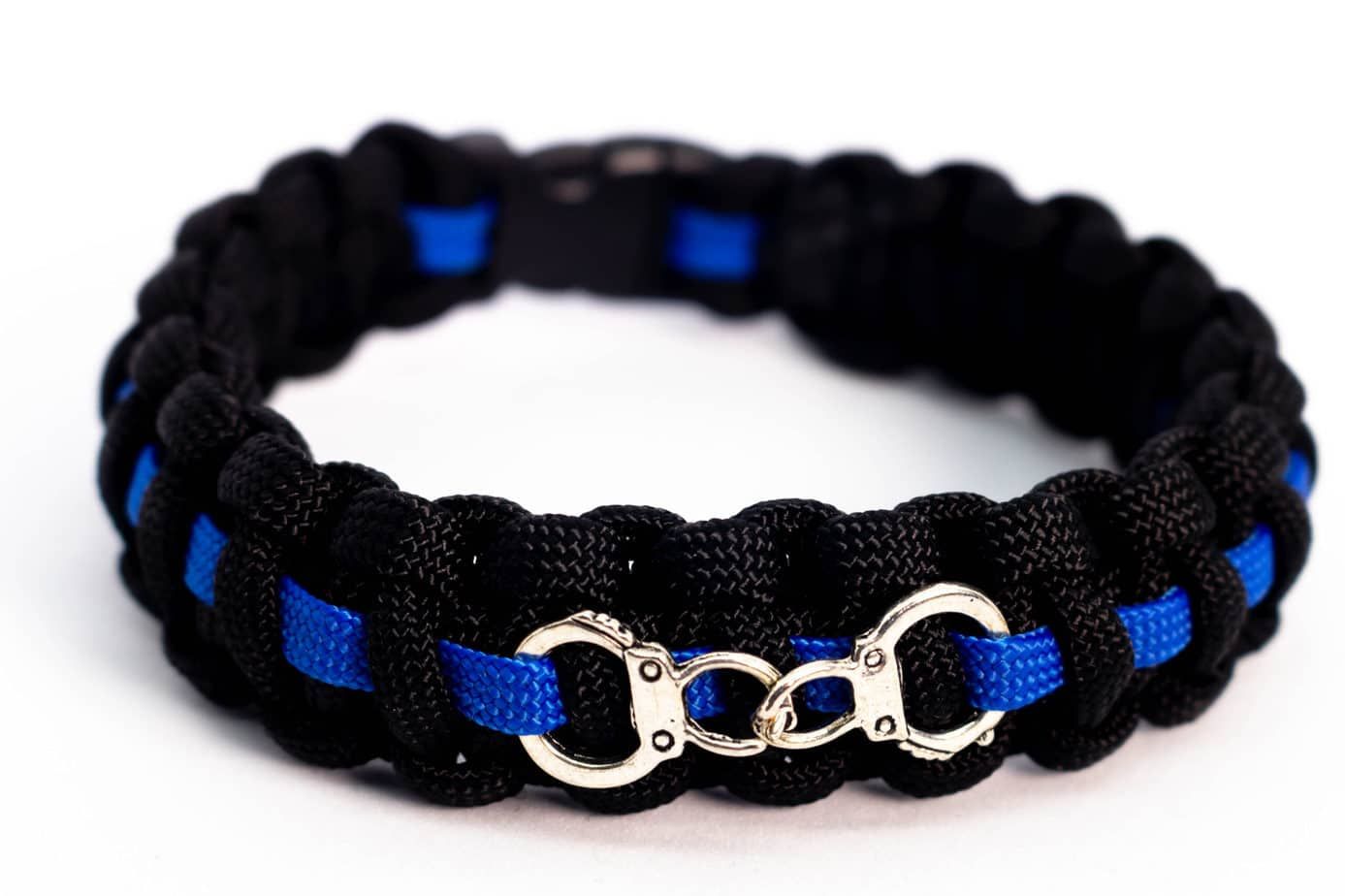 Black and blue paracord bracelet with a thin blue line and silver handcuff charm.