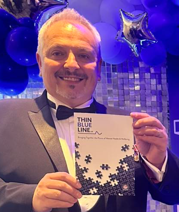 Man in formal wear holds a 