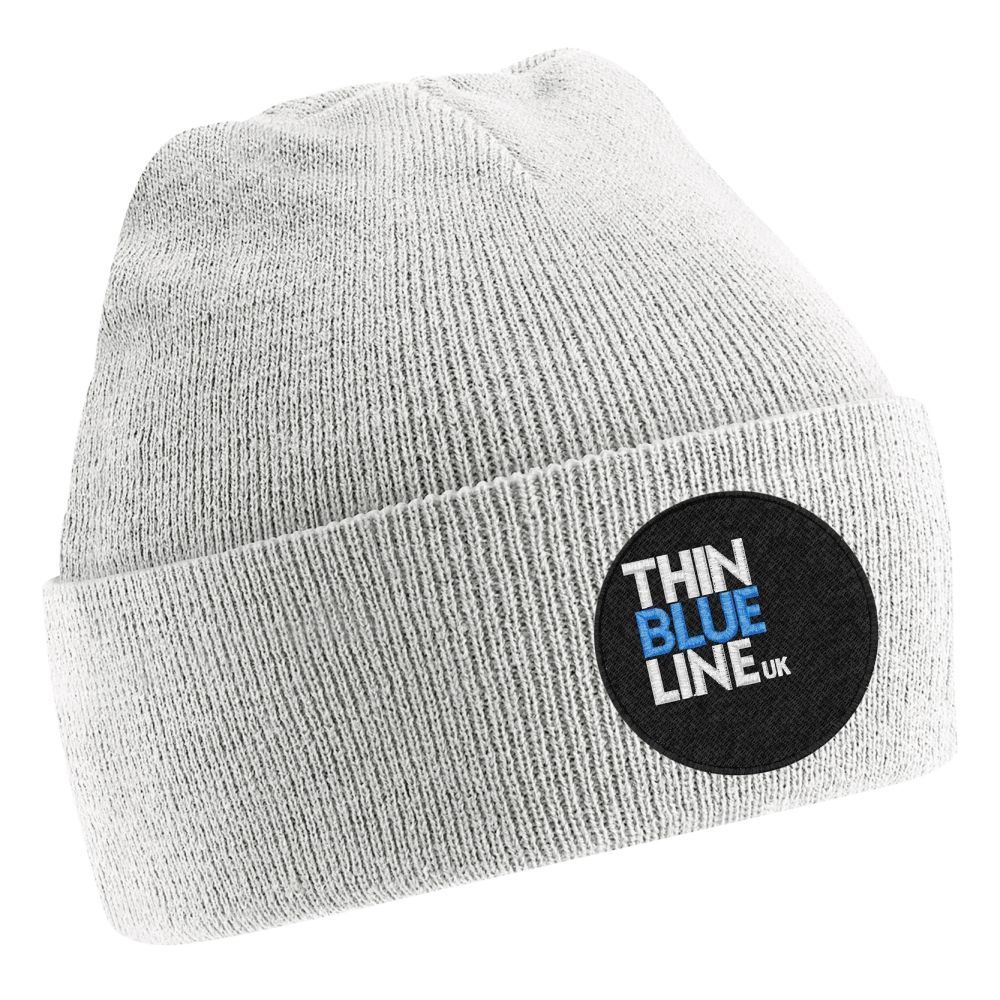 White beanie with a round patch: