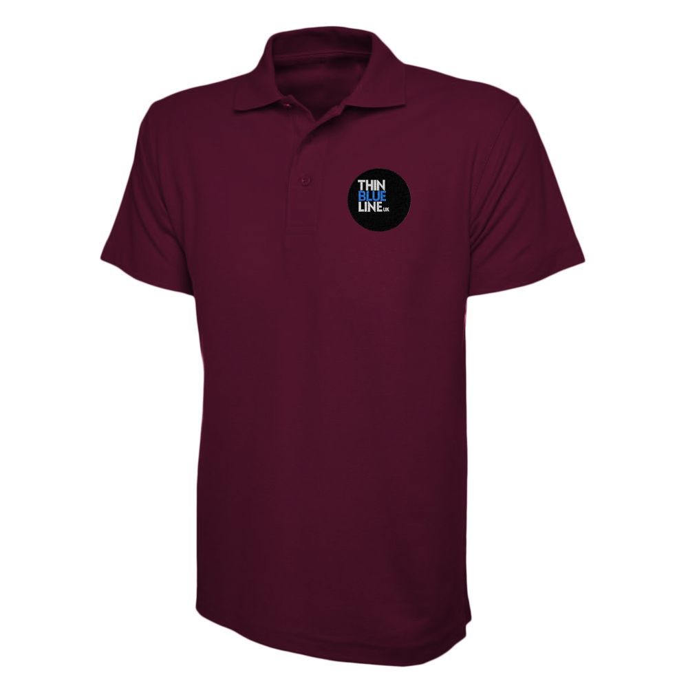 Green polo shirt with a logo on the left breast.