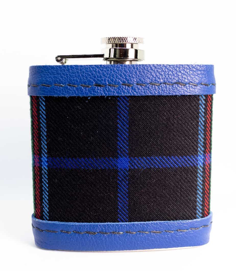 Flask with a plaid fabric body and blue leather trim.