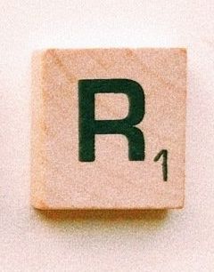 Wooden Scrabble tile with a black