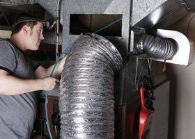 A Man is Working on an Air Duct