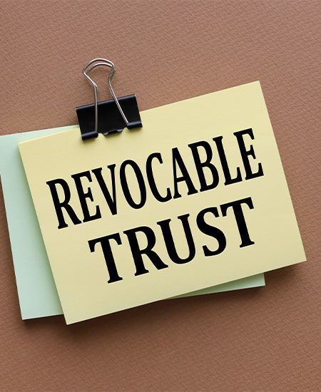 A sticky note with the words revocable trust written on it