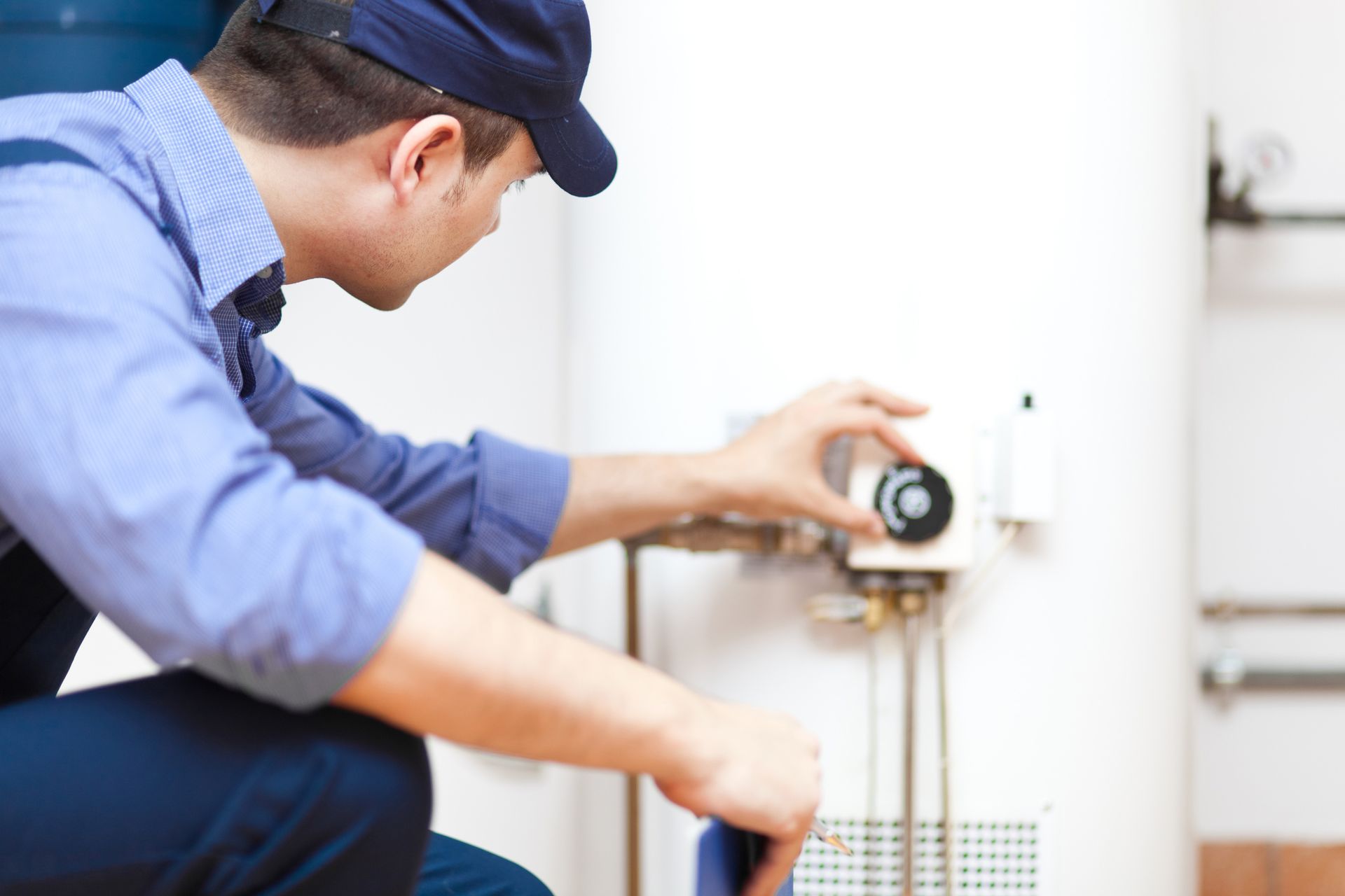 Technician Repairing a Hot Water Heater — Brainerd, MN — DB Plumbing LLC