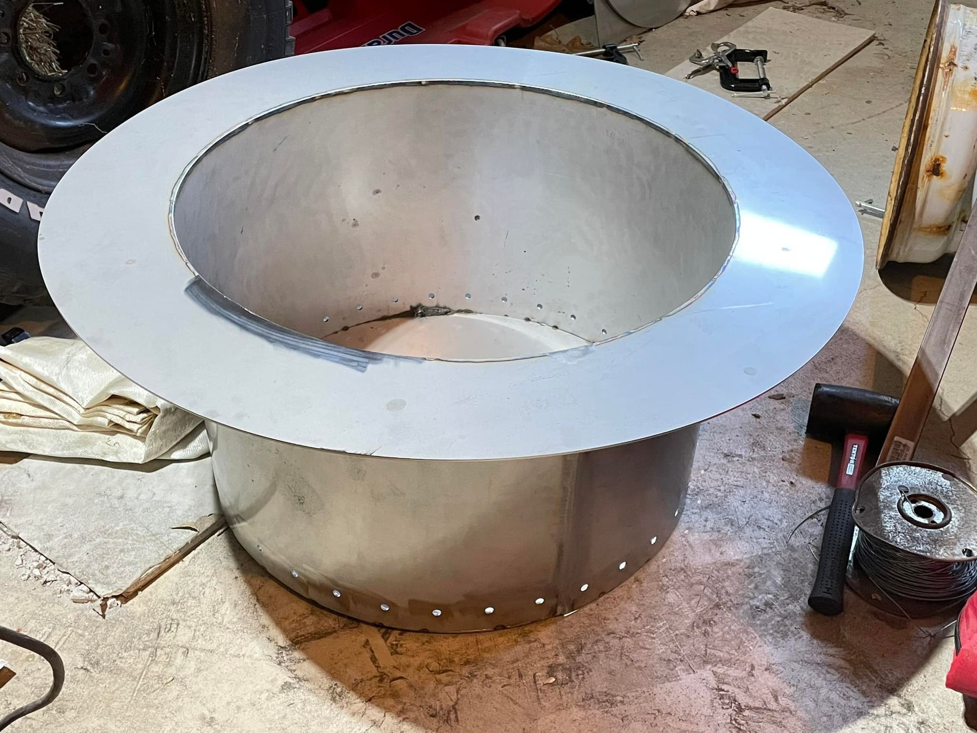 A metal cylinder with a hole in the middle is sitting on a table.