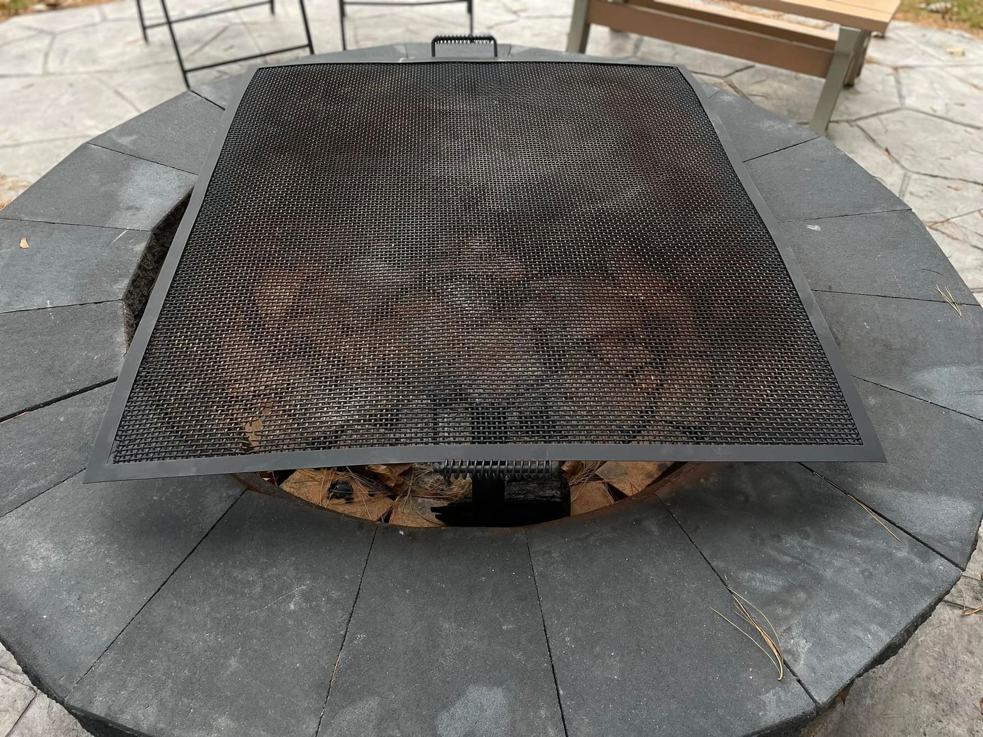 A fire pit with a grill on top of it