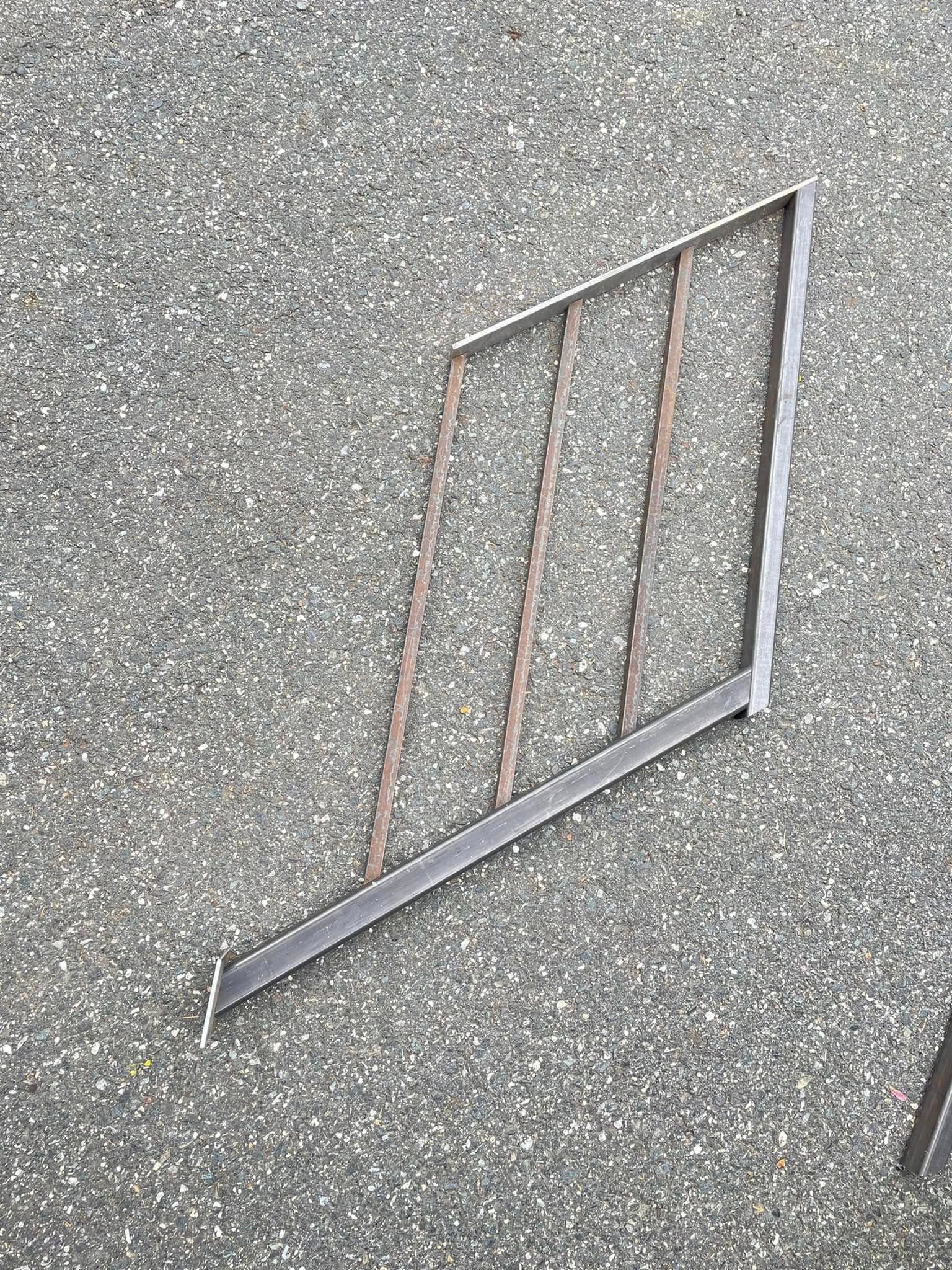 A piece of metal is laying on the ground.