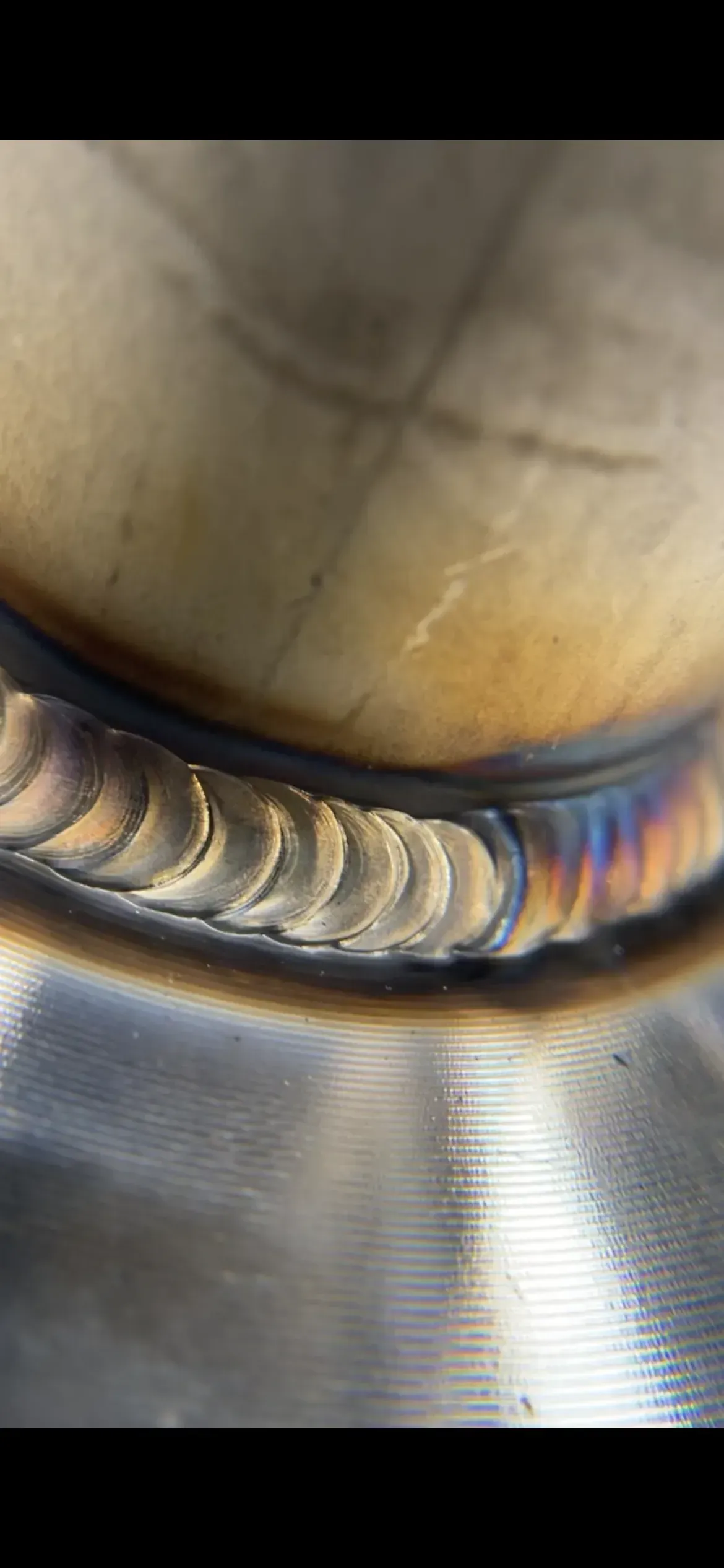 A close up of a welding joint on a metal surface.