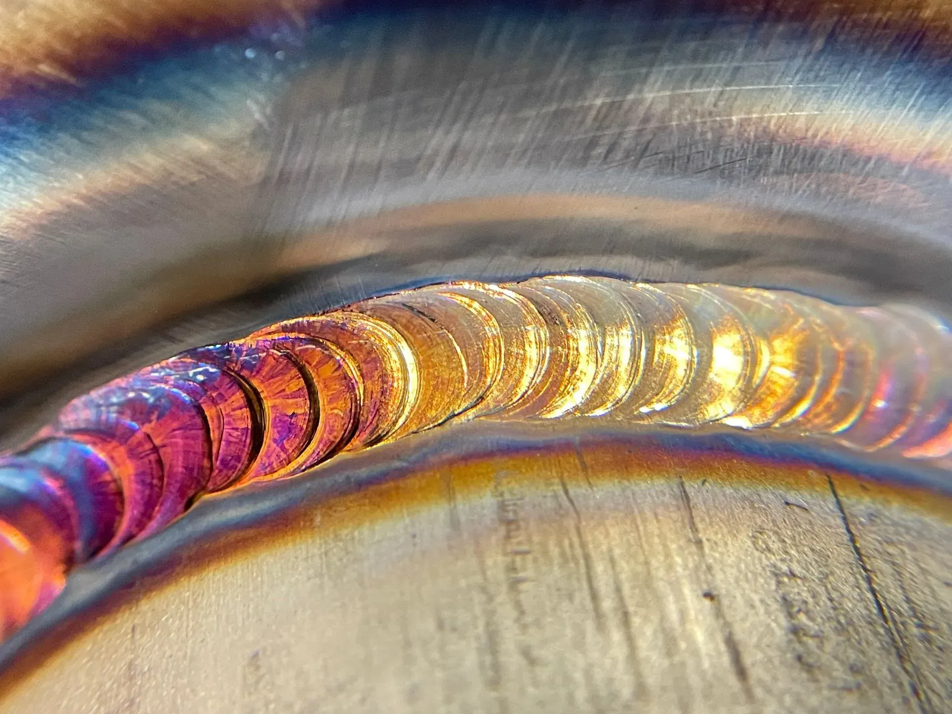 A close up of a welding joint on a metal pipe.