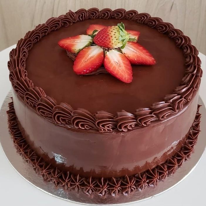 A chocolate cake with strawberries on top of it