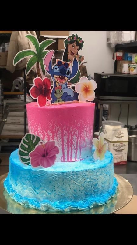 A cake with a lilo and stitch topper on top of it.