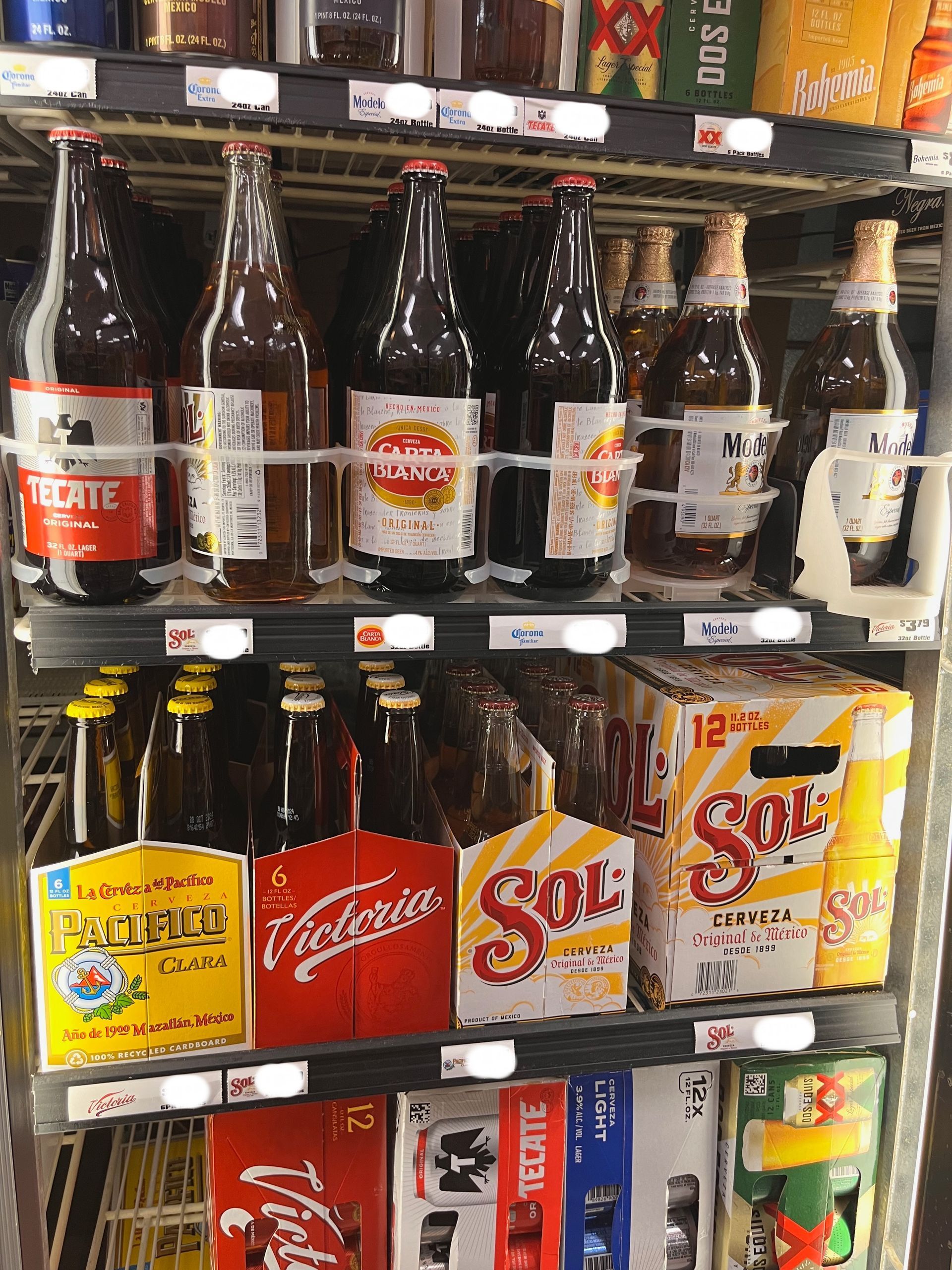 A cooler filled with bottles of beer including sol