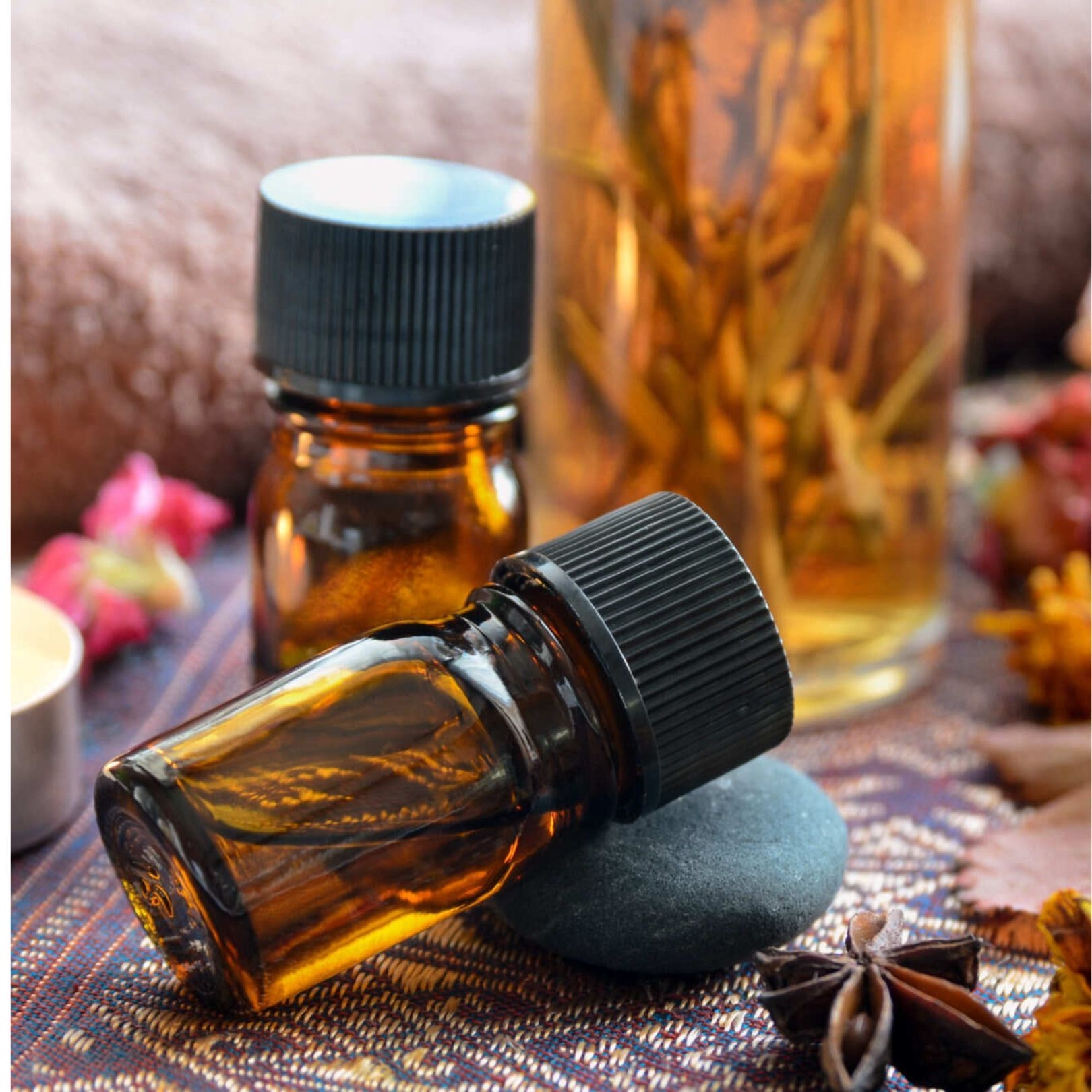 Amber essential oil bottles, spa setting.