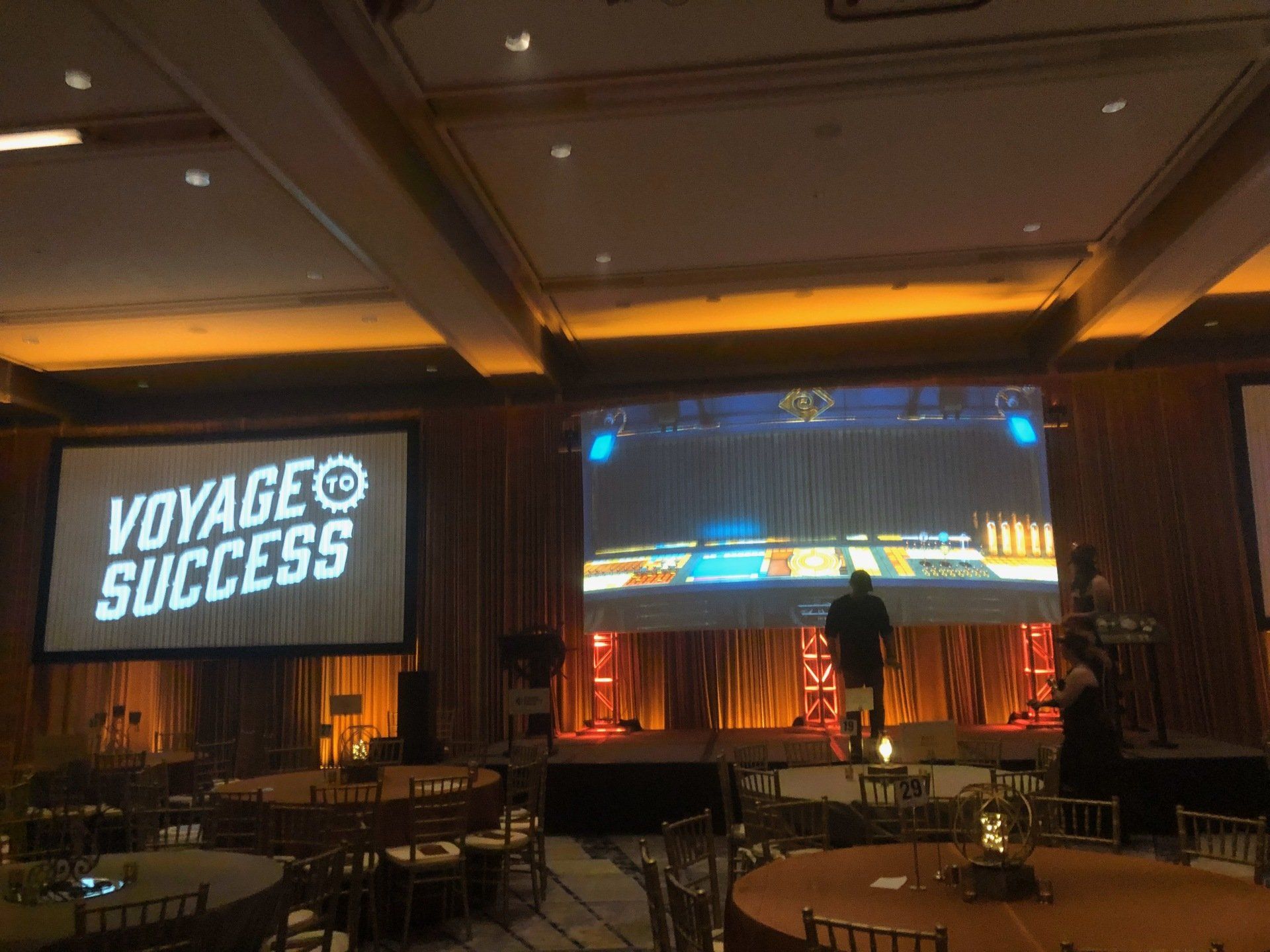 Conference room with stage, screens displaying