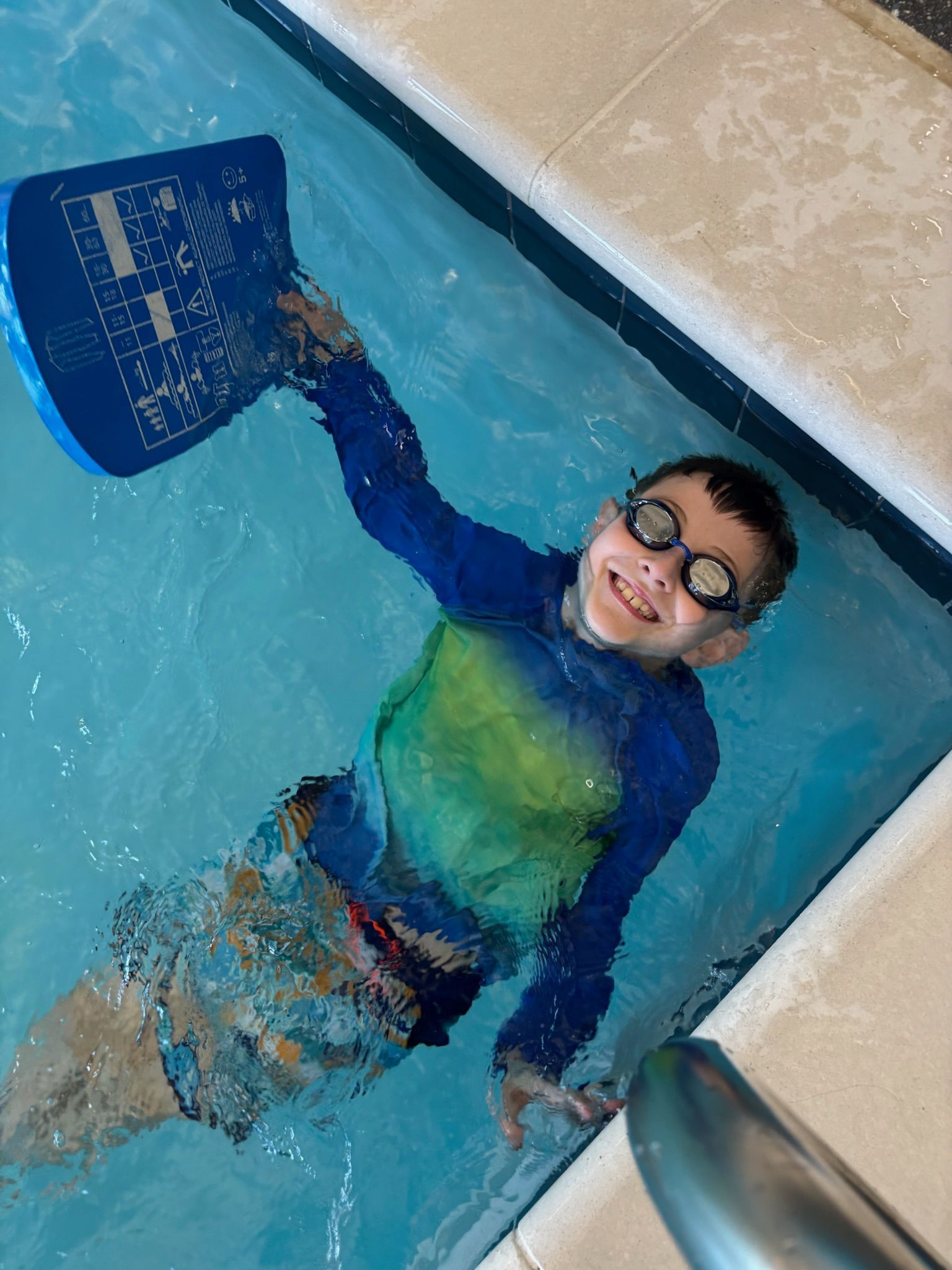 A swimming instructor teaching a child how to float in a pool.