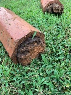 Large Old Pipe On Grass — Rocky Mount, NC — Boswell & Son Septic Tank Service Inc.