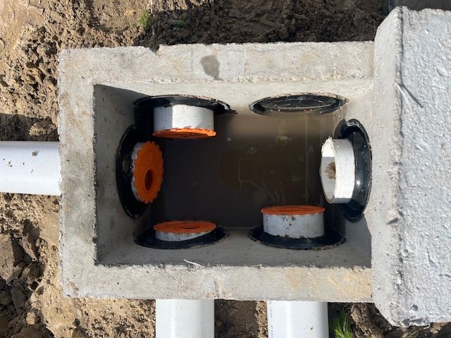 An aerial view of a concrete box with pipes coming out of it.
