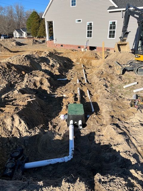 A construction site with a house in the background