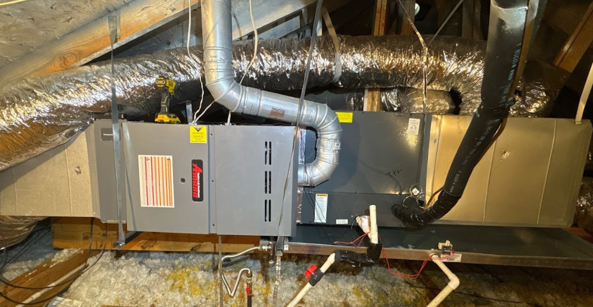 An air conditioner is installed in the attic of a house.