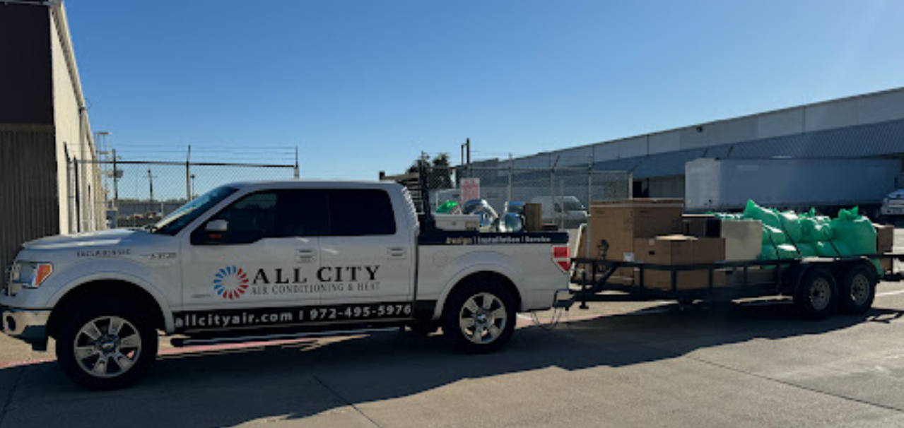 A white truck is pulling a trailer full of boxes.