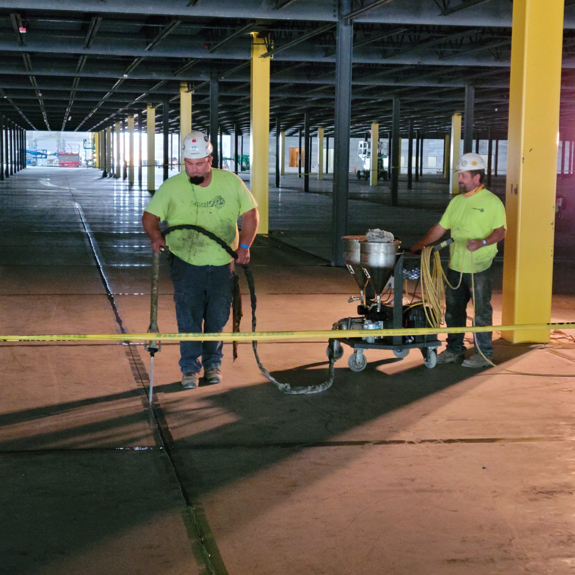 Ameriseal team applying caulking epoxy to the floor of a parking garage in Lordstown