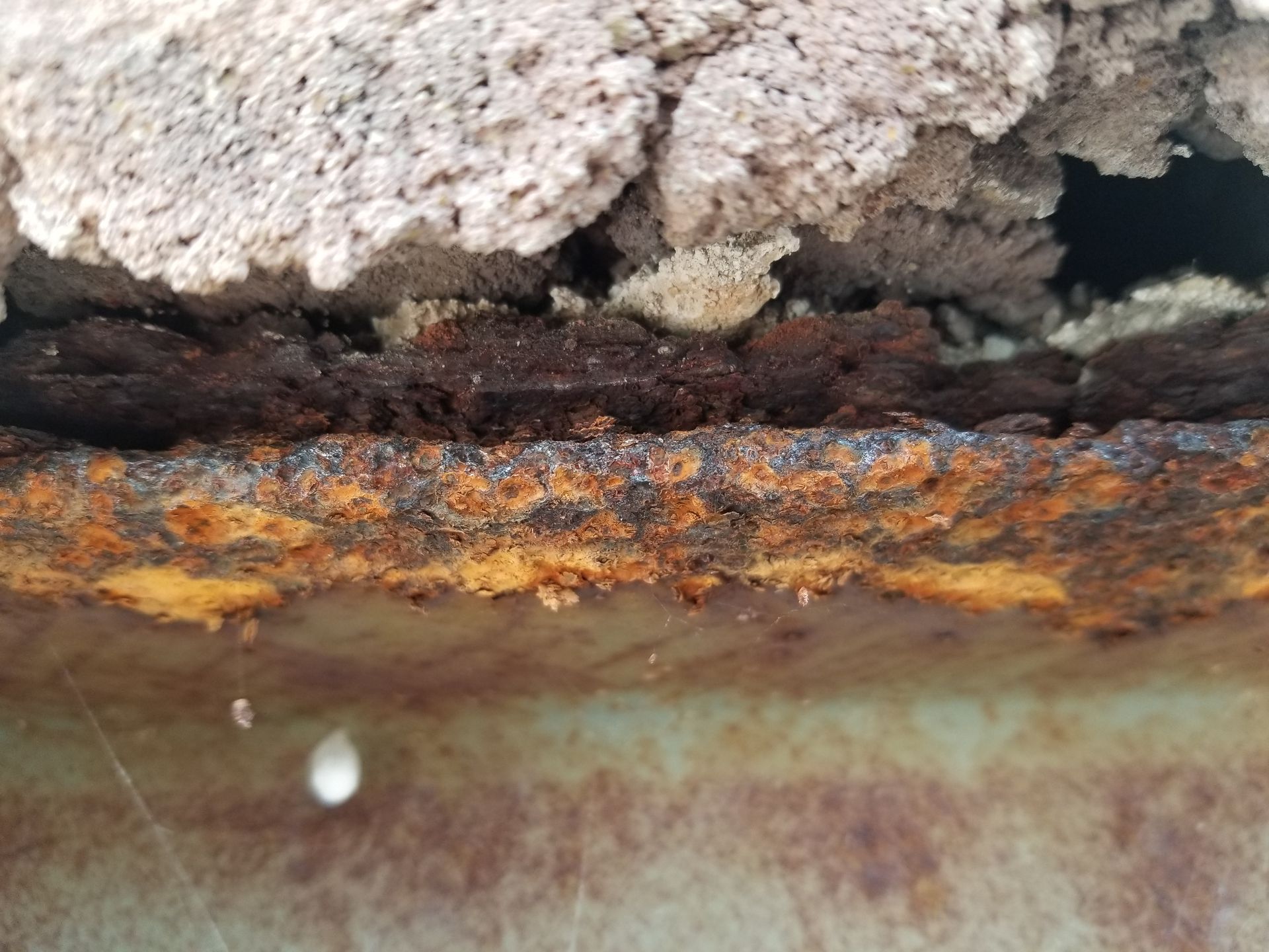 Close up of rust damage occuring to the structural beams under the stone