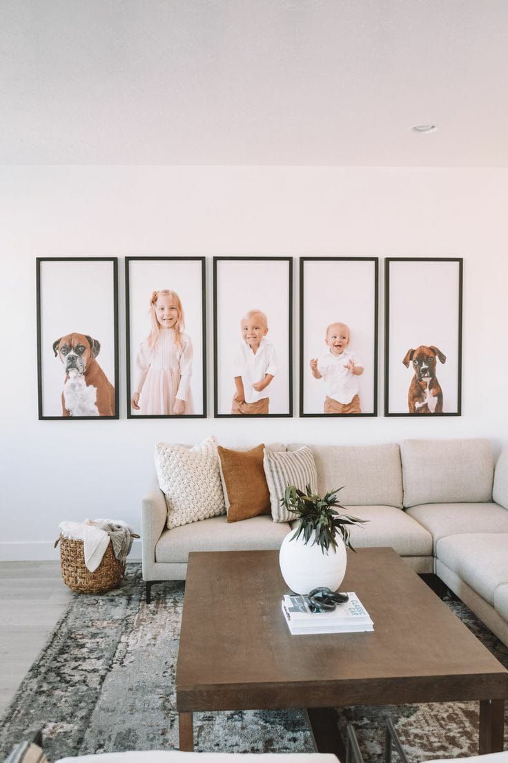 Five Framed Portraits Above a Beige Couch in Living Room — Tropical North Framing Gallery Cairns in Cairns, QLD