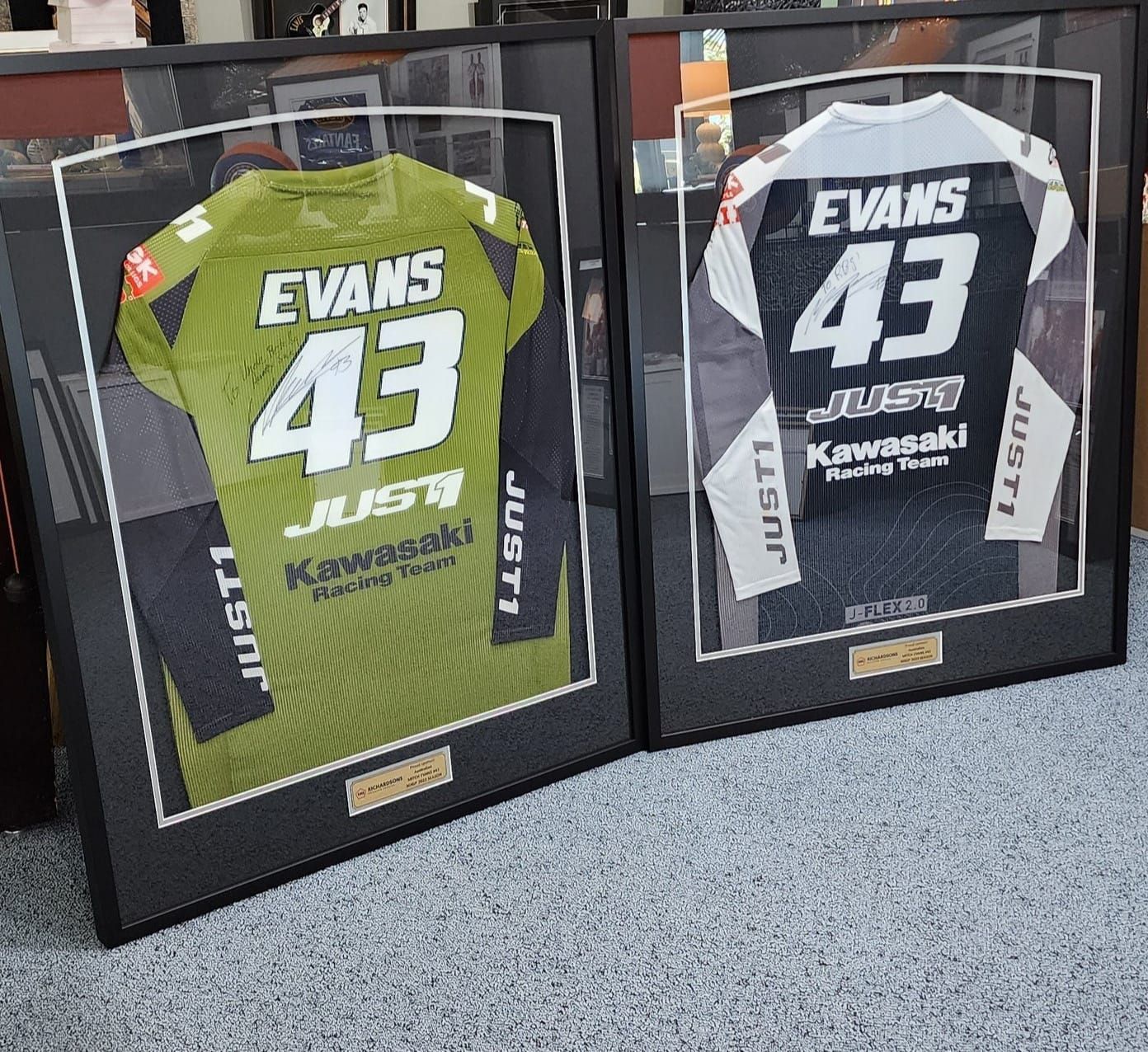 Two Framed Motocross Jerseys, One Green and One Black — Tropical North Framing Gallery Cairns in Bungalow, QLD