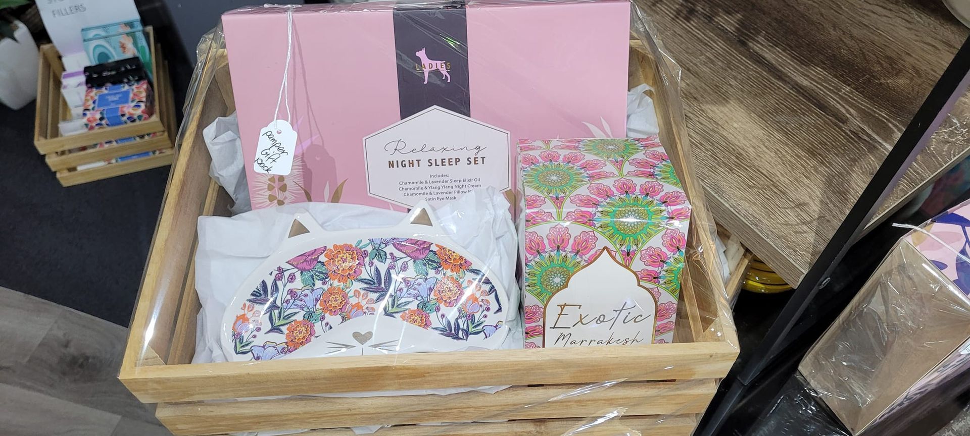 A Gift Basket in a Wooden Crate Containing Pink-themed Items — Tropical North Framing Gallery Cairns in Cairns, QLD