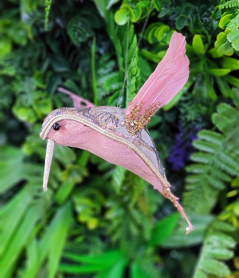 A Pink Hummingbird-like Ornament With Speckled Detailing — Tropical North Framing Gallery Cairns in Cairns, QLD