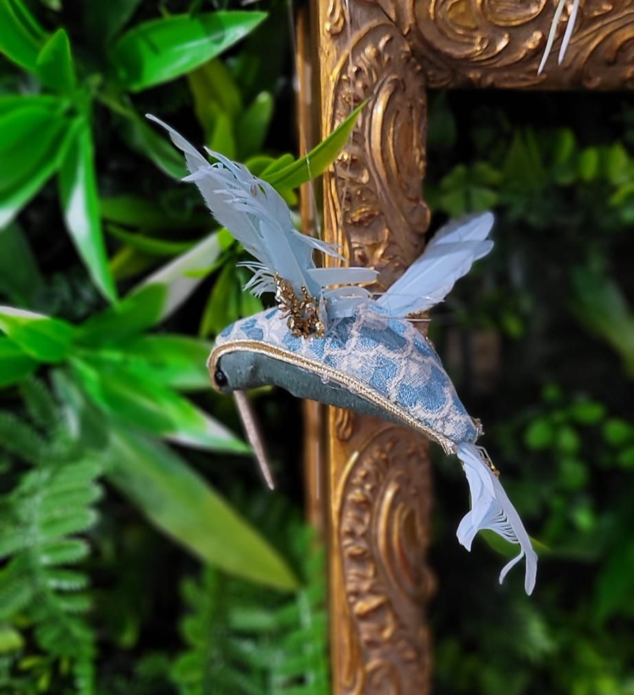 A Decorative Hummingbird Sculpture on a Golden Framed Wall — Tropical North Framing Gallery Cairns in Cairns, QLD