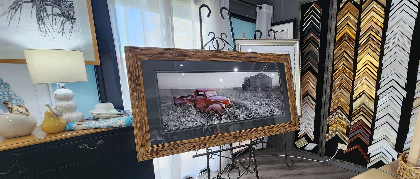 framed photograph of a vintage red truck displayed in a gallery